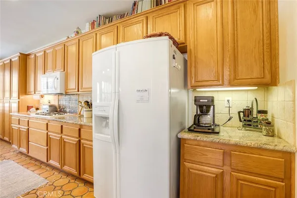 a kitchen with stainless steel appliances a refrigerator and cabinets
