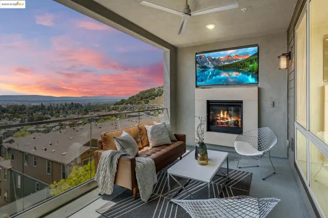 a living room with fireplace furniture and a large window
