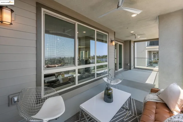a living room with furniture and view of kitchen