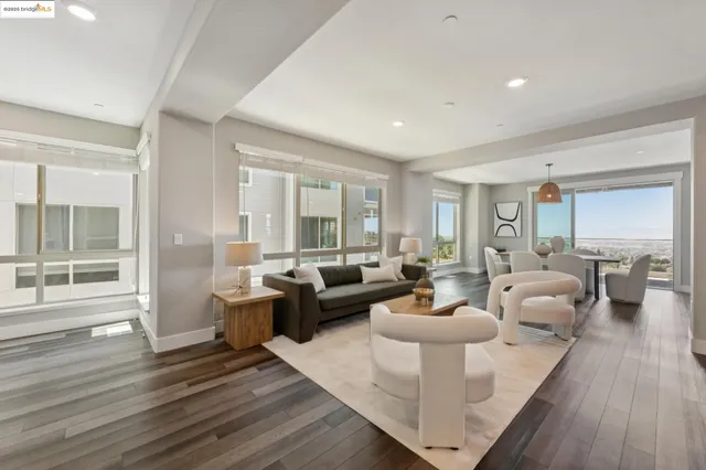 a kitchen with a dining table chairs refrigerator and microwave