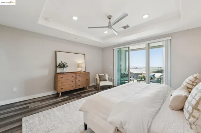 a bathroom with a granite countertop double vanity sink a mirror and a shower