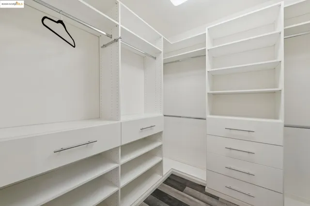 a bedroom with a bed and windows