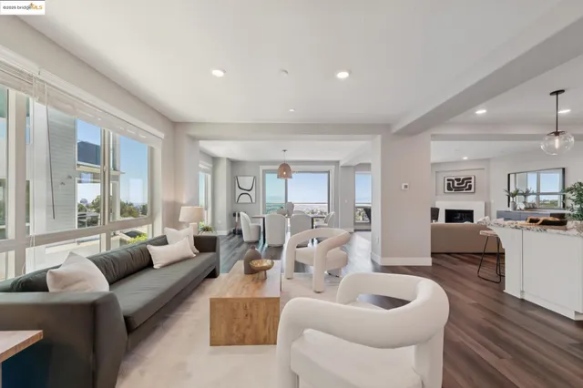 a living room with furniture a dining table and a chandelier