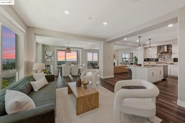 a living room with furniture a window and wooden floor