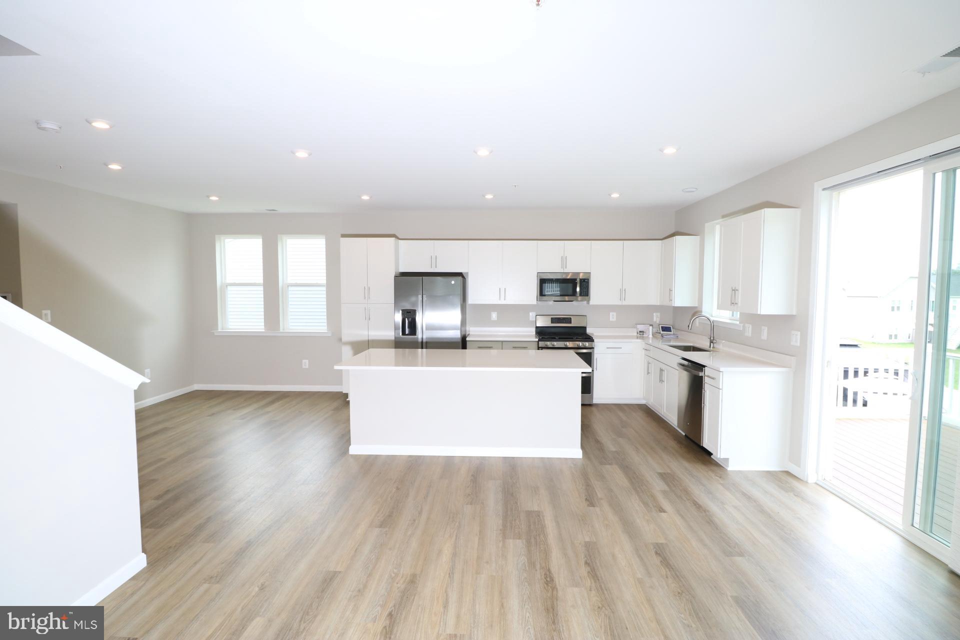 12312 Fallen Timbers Circle Hagerstown, MD 21740 - Photo 18 of 28 a kitchen with a white stove top oven and white cabinets