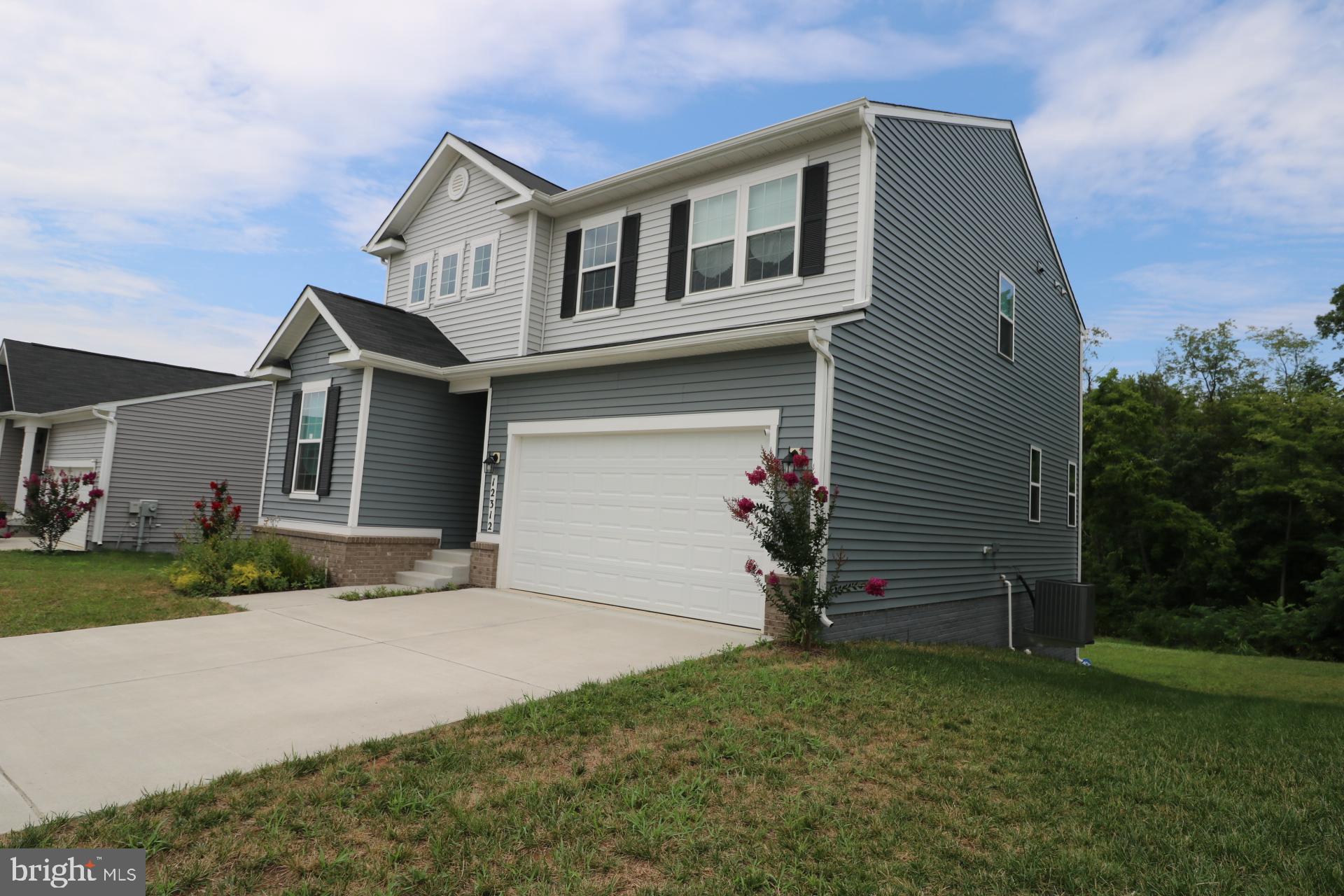12312 Fallen Timbers Circle Hagerstown, MD 21740 - Photo 2 of 28 a front view of a house with a yard and garage