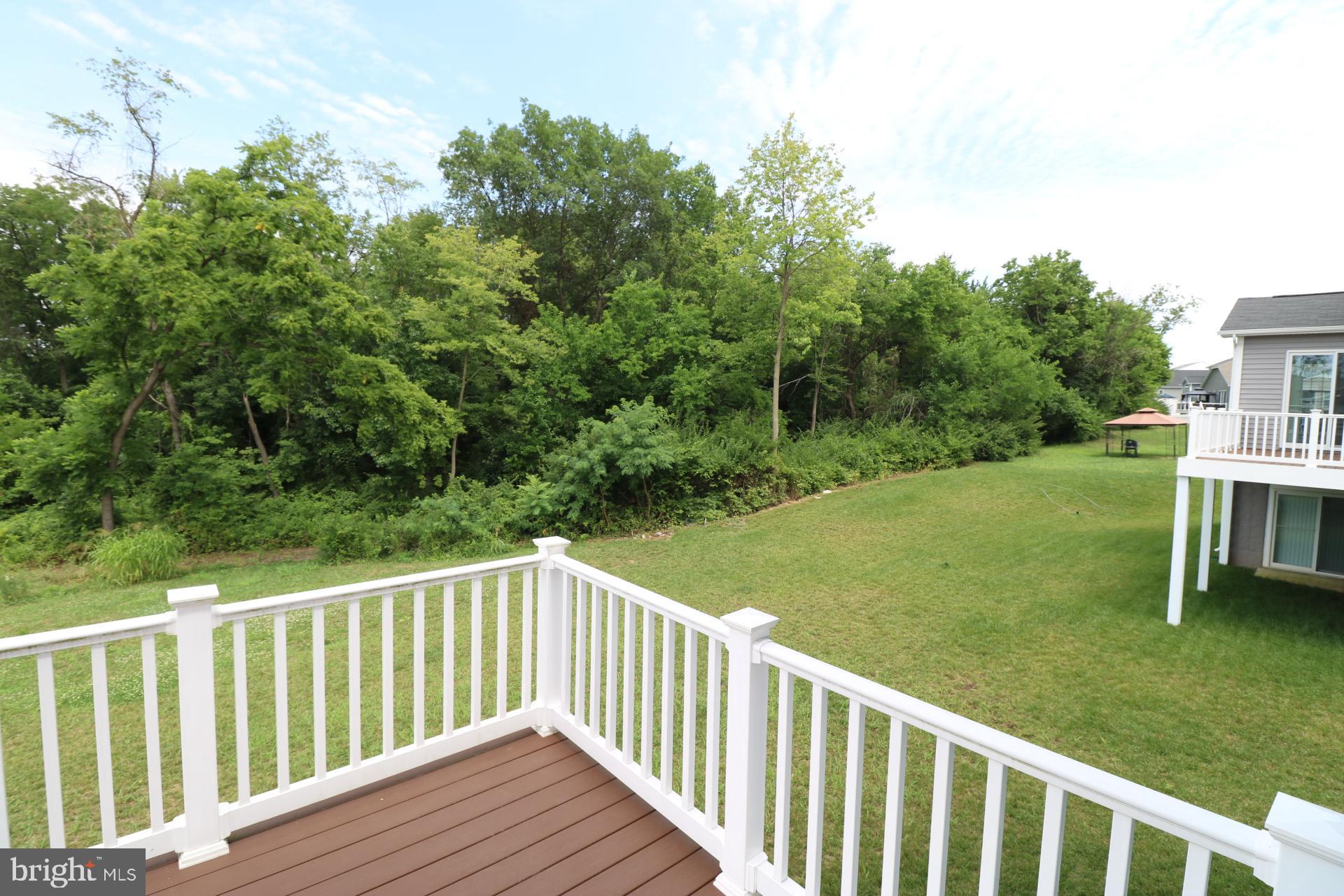 12312 Fallen Timbers Circle Hagerstown, MD 21740 - Photo 21 of 28 a view of a wooden deck and yard with green space