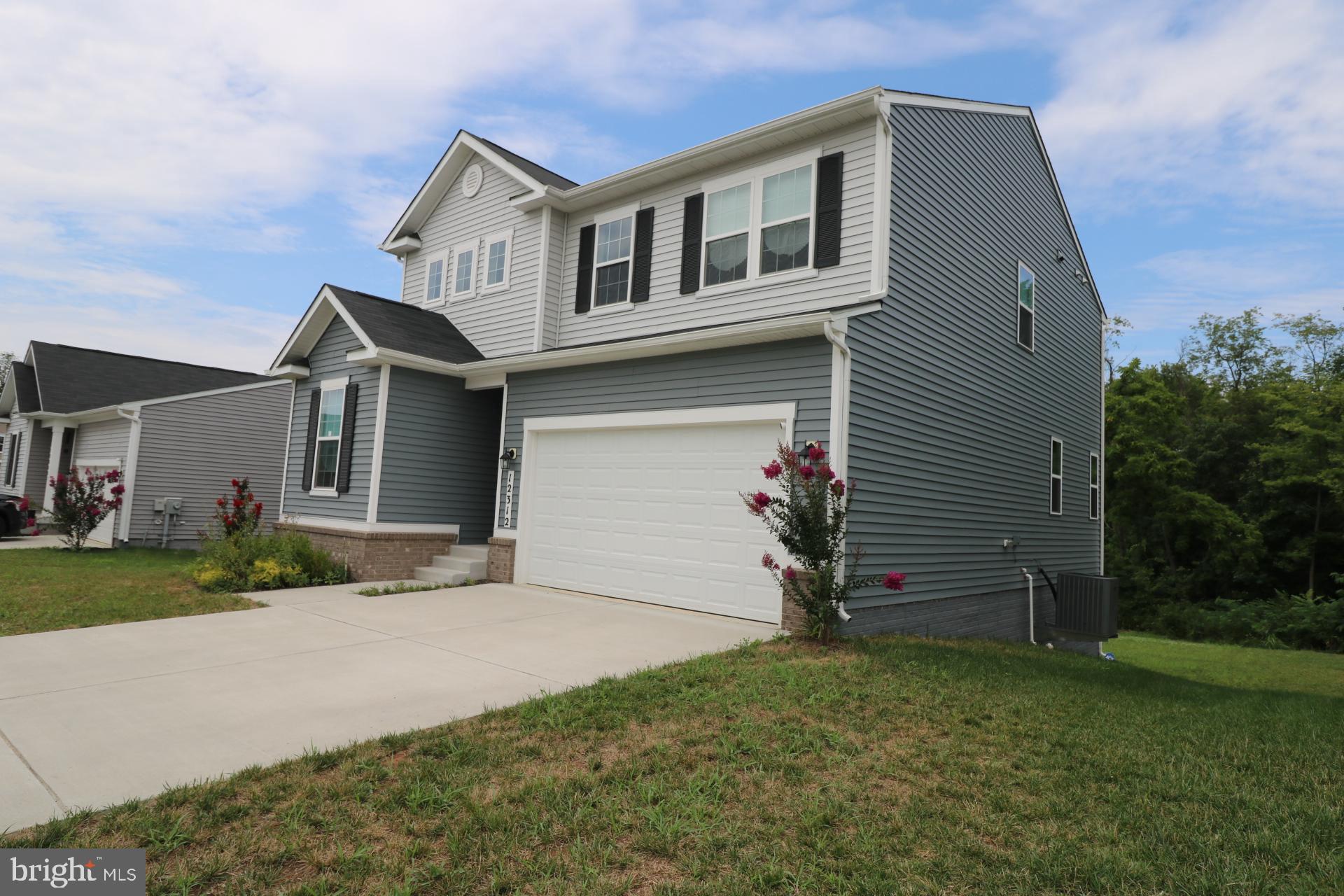 12312 Fallen Timbers Circle Hagerstown, MD 21740 - Photo 3 of 28 a front view of a house with a yard and garage