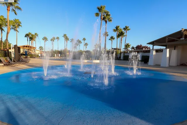 a view of a lake with a table and chairs