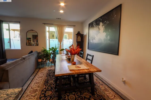 a dining room with furniture and wooden floor