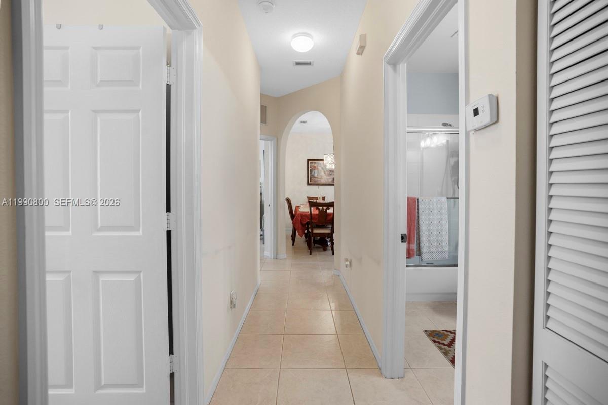 337 Southwest Maclay Way Port St. Lucie, FL 34986 - Photo 20 of 44 a view of a hallway with livingroom and a livingroom with furniture