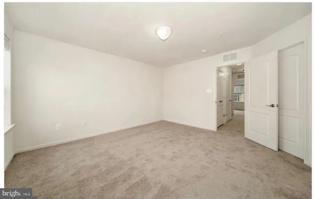 an empty room with an entrance to other room