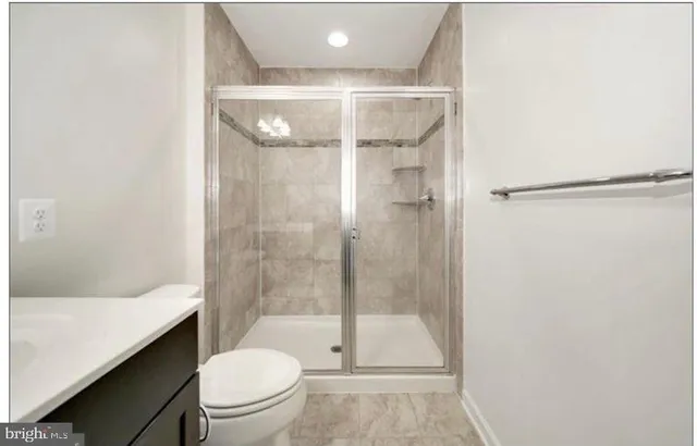 a bathroom with a shower a toilet and sink
