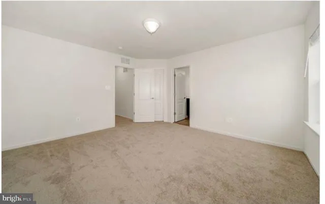 a view of a house with roof and parking