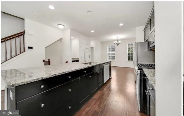 a spacious bathroom with a granite countertop sink a mirror and shower