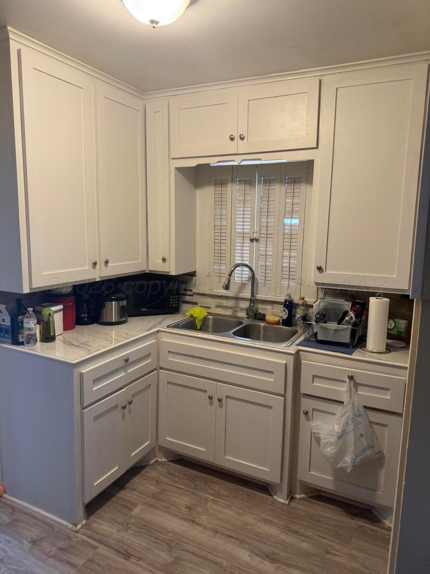 1209 Southwest 10th Avenue Amarillo, TX 79101 - Photo 5 of 6 a kitchen with a sink cabinets and wooden floor