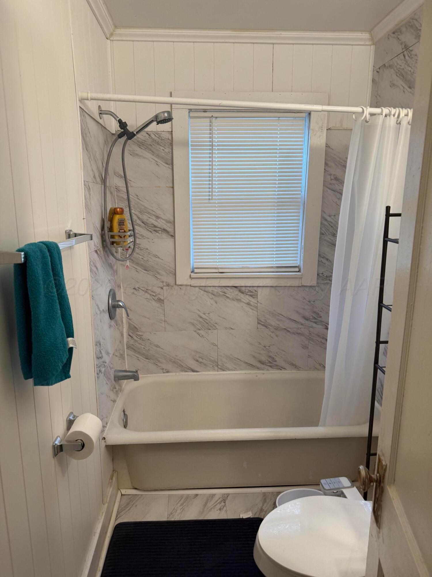 1209 Southwest 10th Avenue Amarillo, TX 79101 - Photo 6 of 6 a bathroom with a toilet and a shower