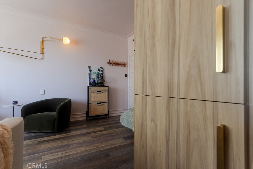 800 East Ocean Boulevard, Unit 1007 Long Beach, CA 90802 - Photo 17 of 43 a hallway with a couch and a dresser with wooden floor