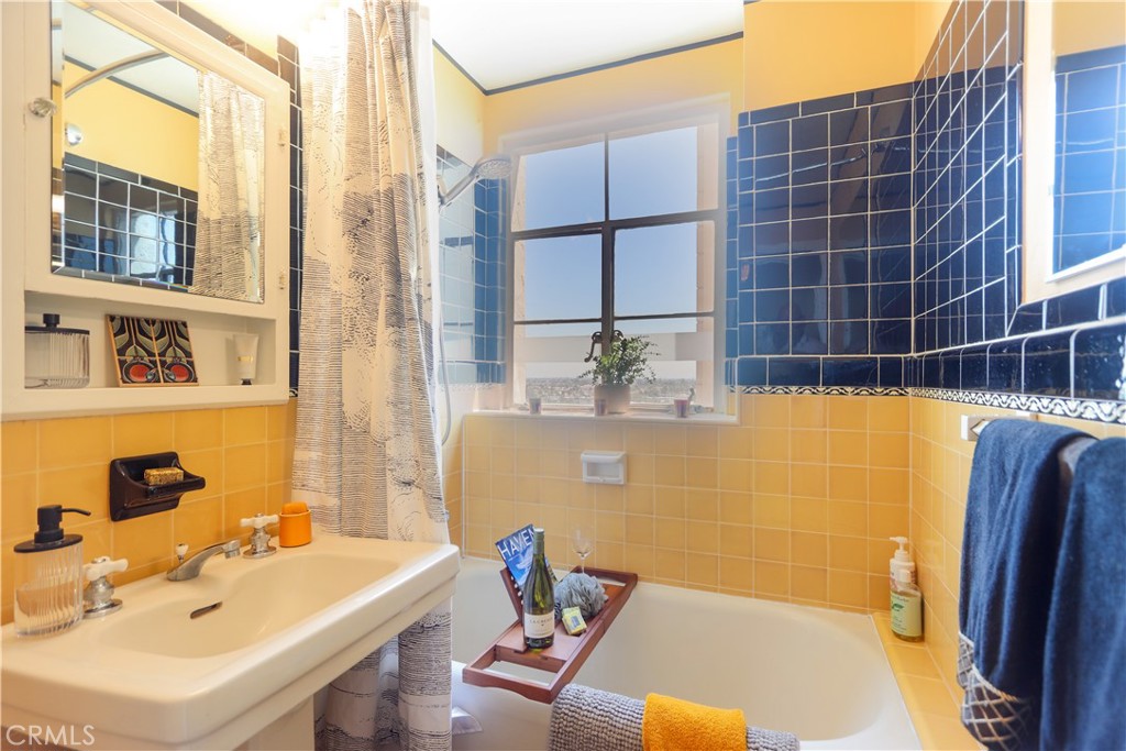 800 East Ocean Boulevard, Unit 1007 Long Beach, CA 90802 - Photo 19 of 43 a bathroom with a tub sink and a mirror