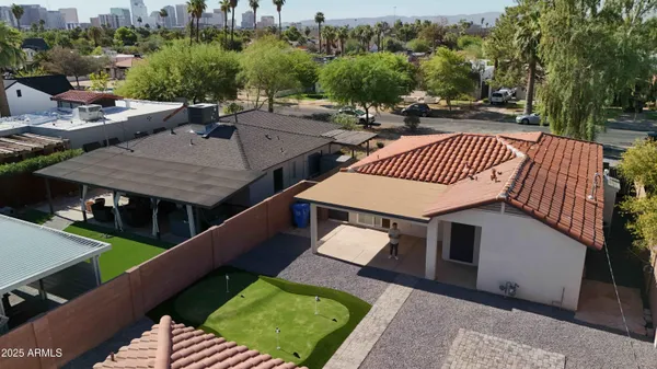 a view of a backyard with table and chairs