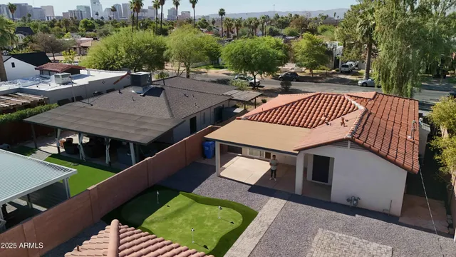 a view of a backyard with table and chairs