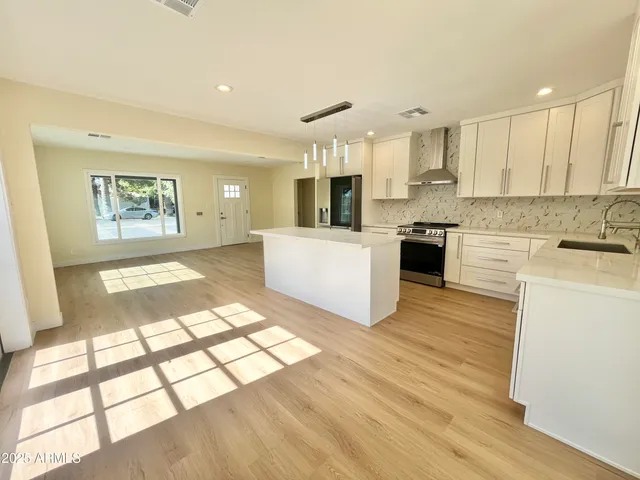 a kitchen with a stove and white cabinets