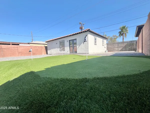 a bathroom with a glass shower door and a window