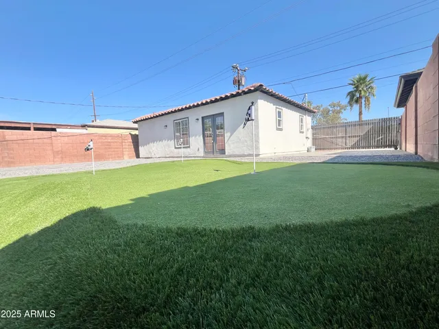 a bathroom with a glass shower door and a window