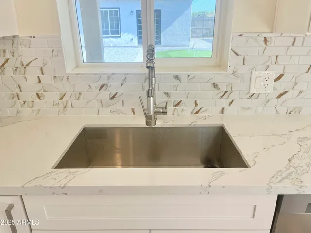 a kitchen with a sink stove and microwave