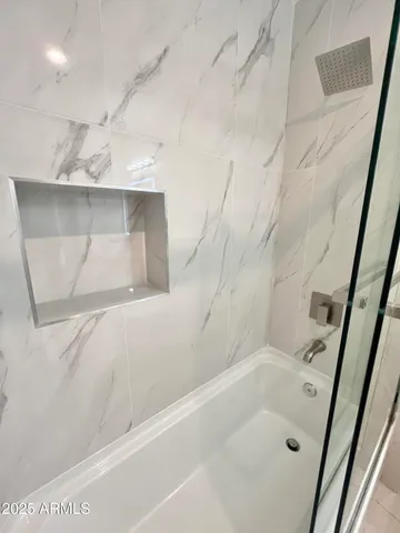 a kitchen with stainless steel appliances a refrigerator and a stove top oven