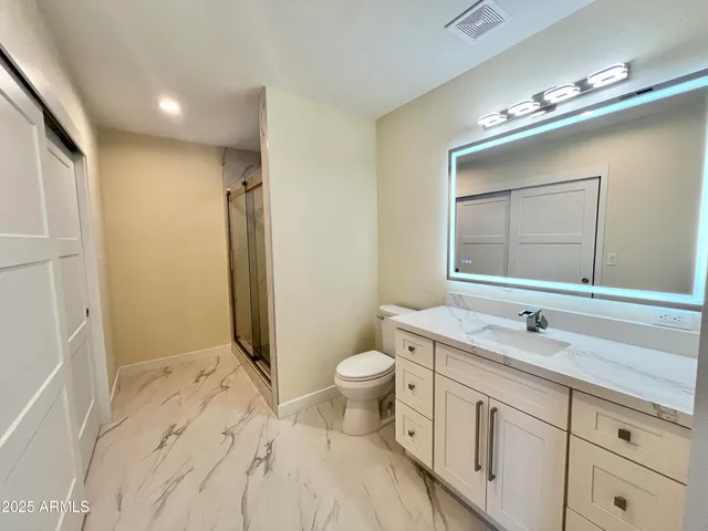 a kitchen with stainless steel appliances a stove top oven a sink dishwasher a refrigerator and a microwave oven with wooden floor