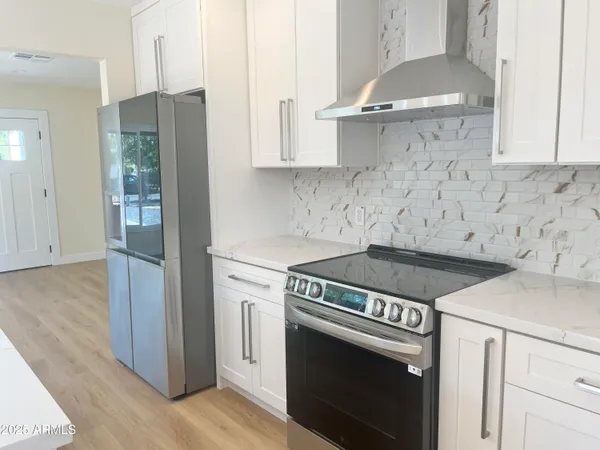 a view of a room with wooden floor