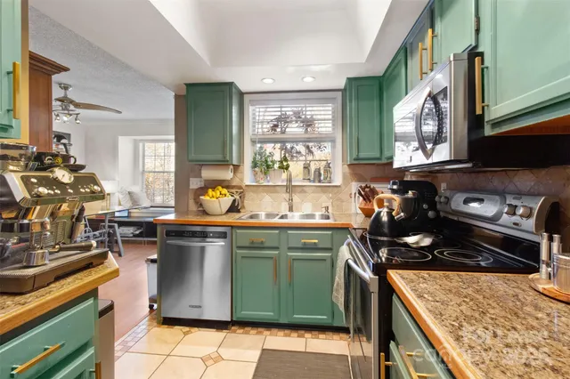 a kitchen with a sink stove and cabinets