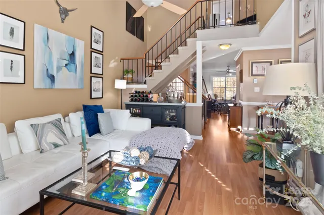 a living room with furniture and wooden floor