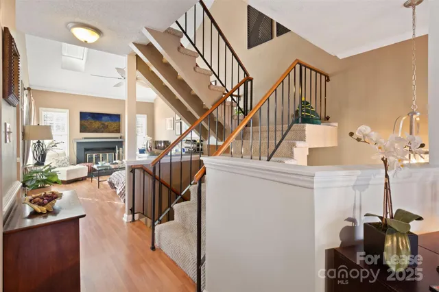 a living room with couches a dining table and chairs with wooden floor