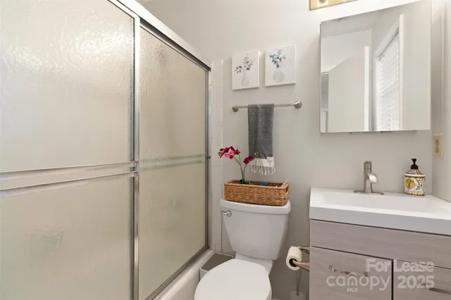 a bathroom with a toilet sink and shower