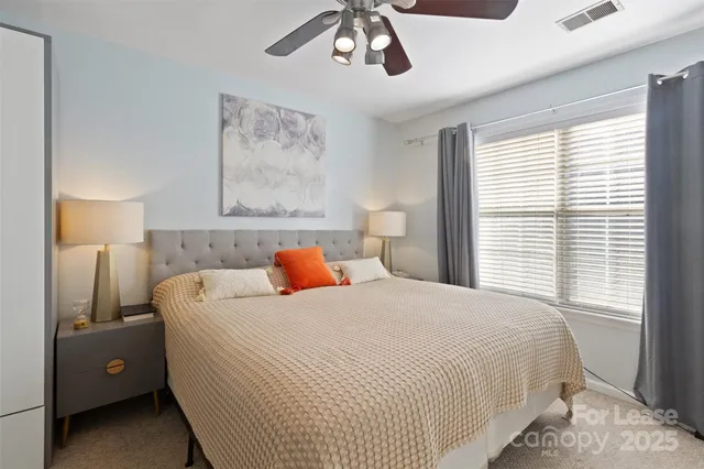 a bedroom with a bed and a large mirror