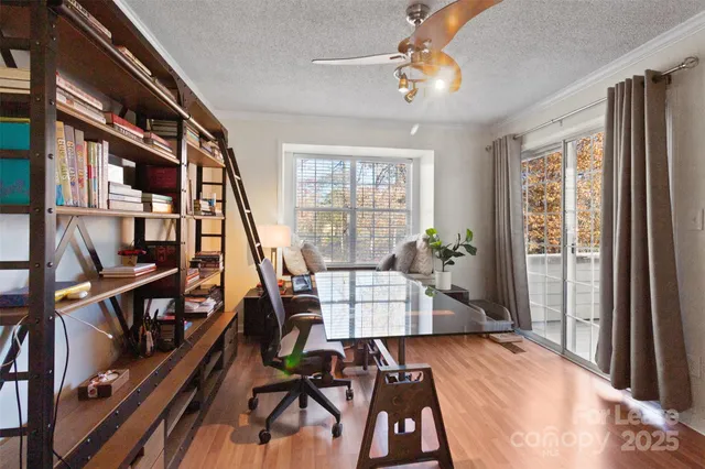 a view of a livingroom with furniture and a book shelf