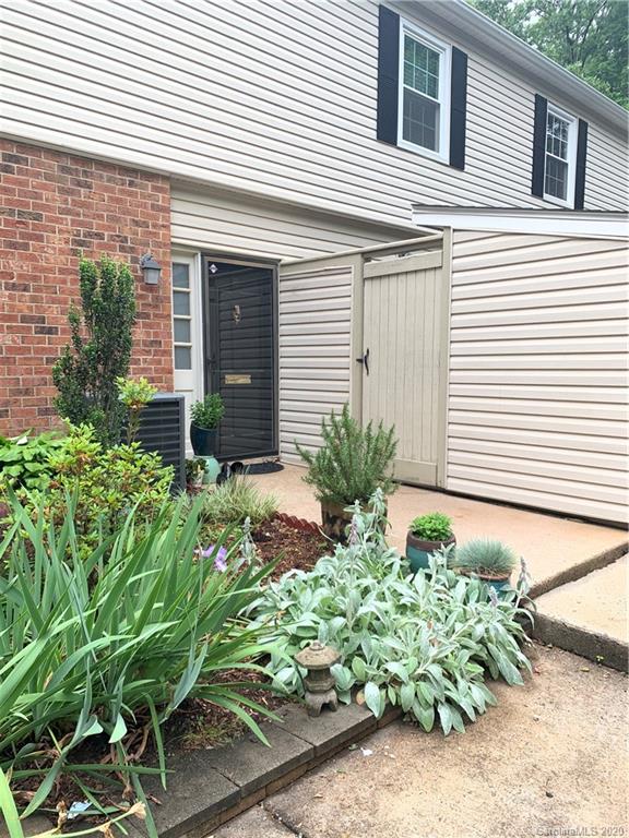5923 Quail Hollow Road, Unit B Charlotte, NC 28210 - Photo 1 of 15 a house with a flower garden