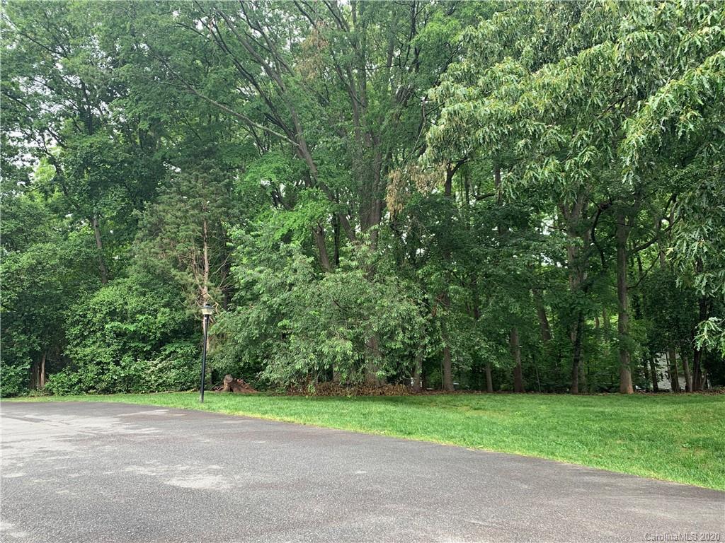 5923 Quail Hollow Road, Unit B Charlotte, NC 28210 - Photo 13 of 15 a view of a road with a small yard and large trees