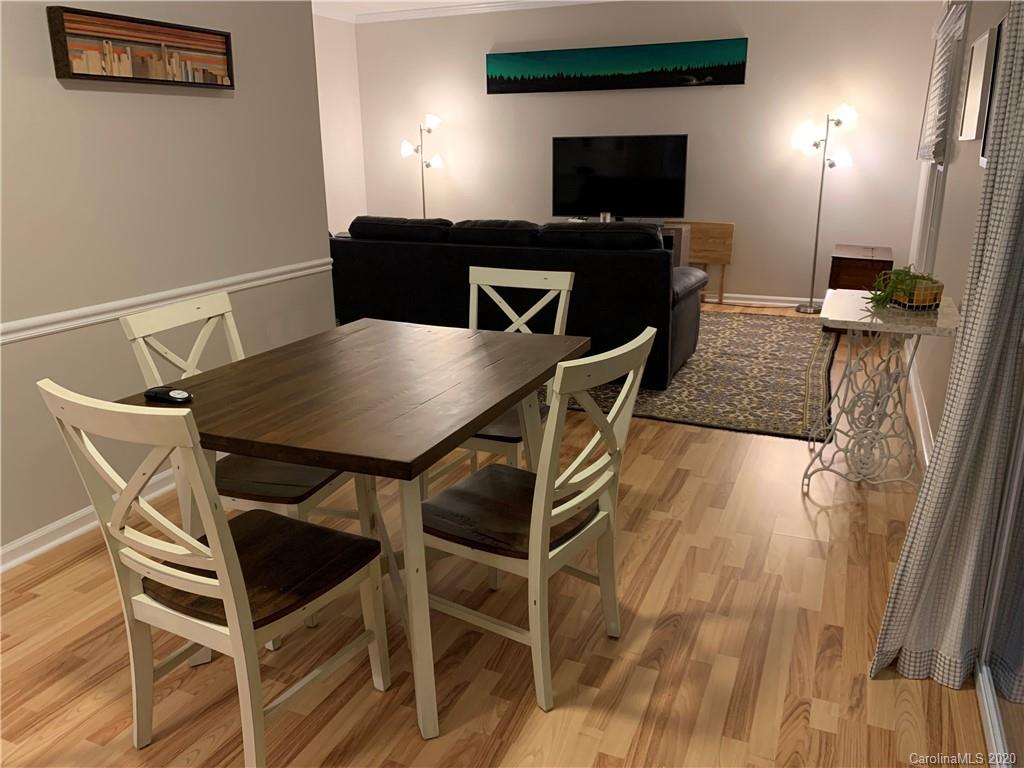 5923 Quail Hollow Road, Unit B Charlotte, NC 28210 - Photo 5 of 15 a view of a dining room with furniture and wooden floor