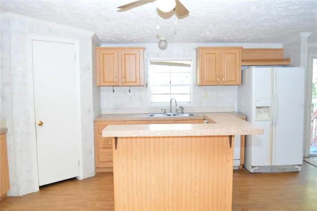 a view of an empty room with a fireplace and a window