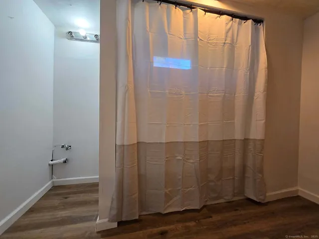 a view of a bathroom with wooden floor
