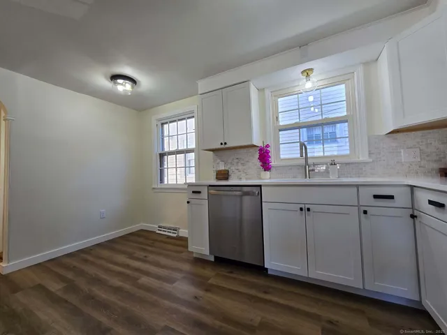 a kitchen with a sink cabinets and window