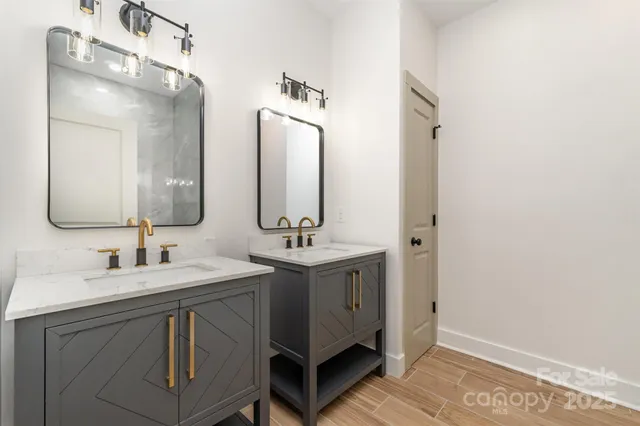 a bathroom with a double vanity sink and a mirror