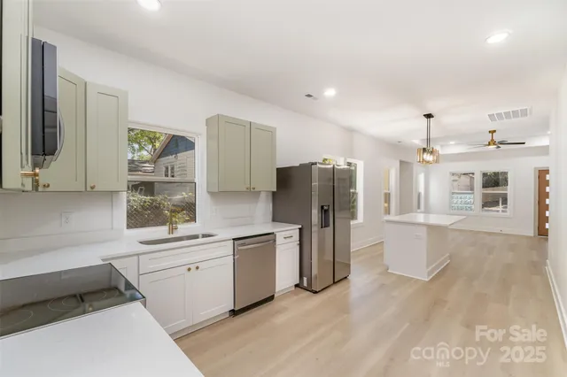 a kitchen with refrigerator and cabinets