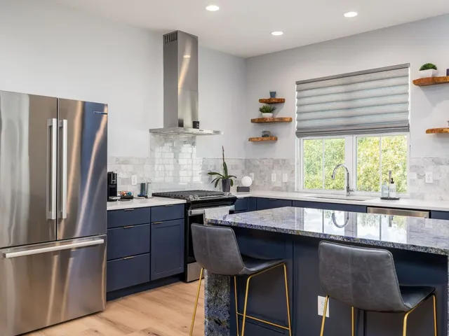 a kitchen with a table chairs refrigerator and cabinets
