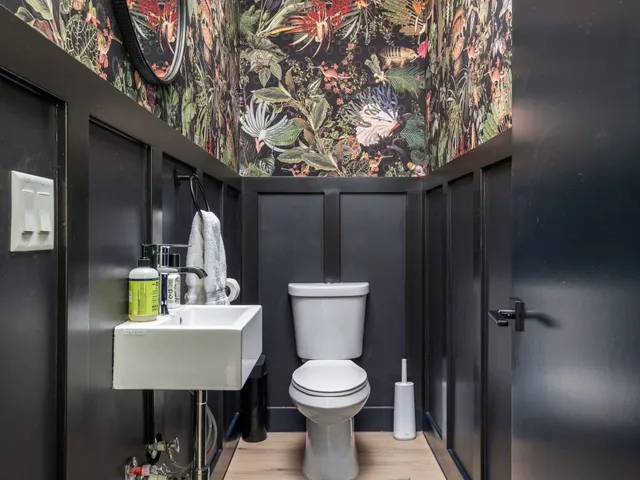 a bathroom with a toilet sink and mirror