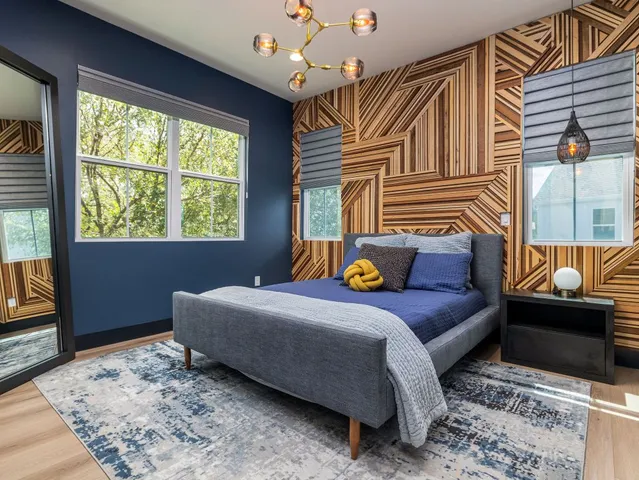 a bedroom with a bed a couch and dresser