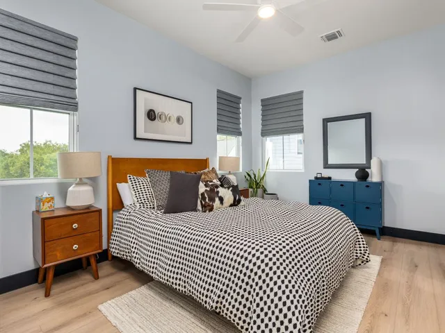 a bedroom with a bed and wooden floor